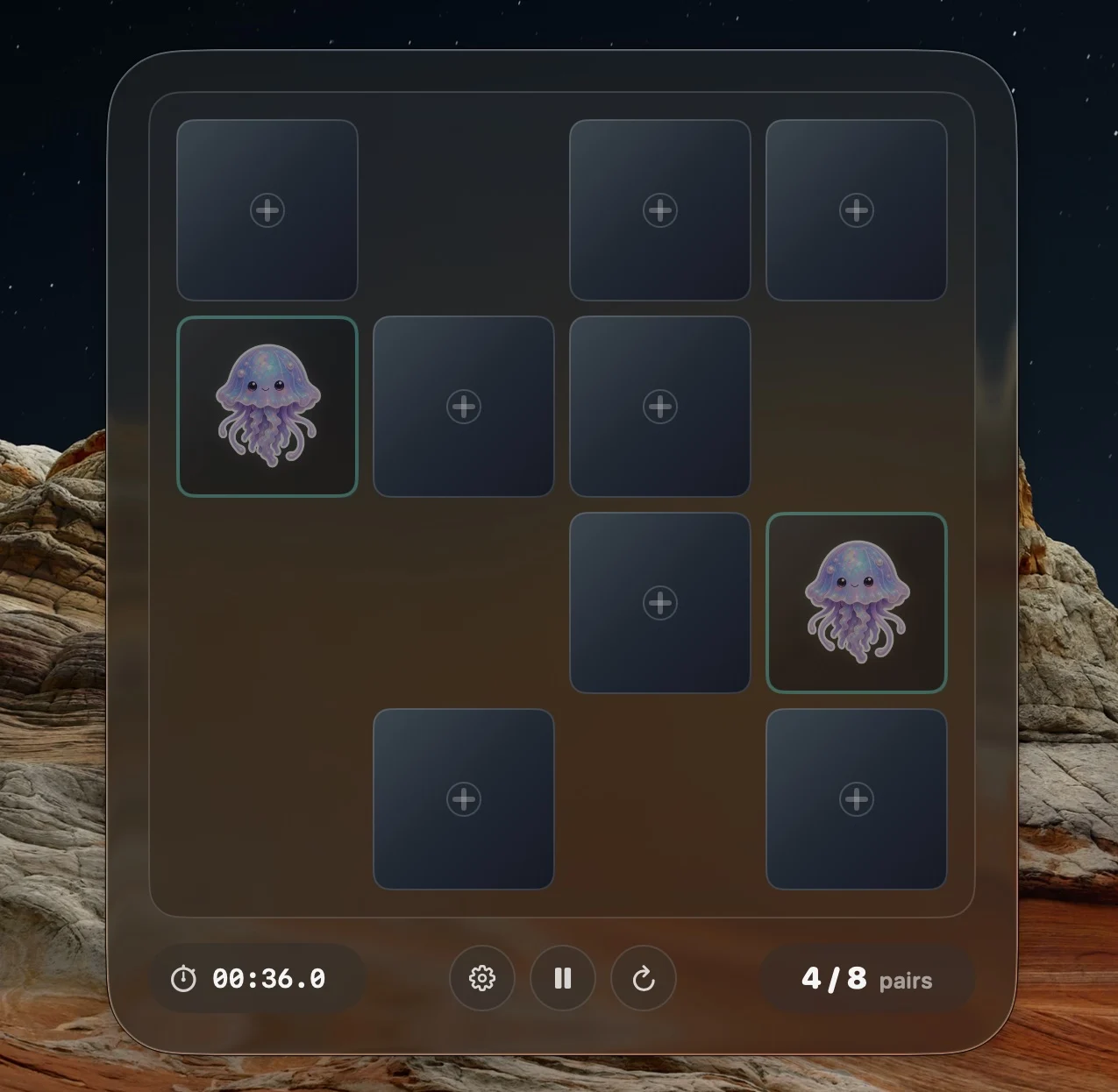 PeekPairs macOS memory game with a dark translucent board, a revealed jellyfish pair and round controls.